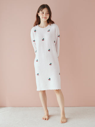Woman wearing cherry pattern jacquard lounge dress with airy moco fabric, light and fluffy texture, ideal for year-round comfort.