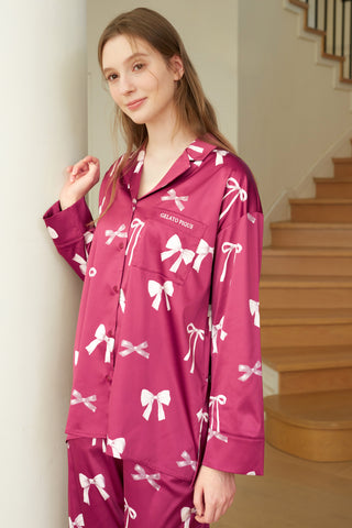 Model wearing pink Ribbon Shirt & Long Pants Set with all-over ribbon print, notched collar, and embroidered "Gelato" on pocket.