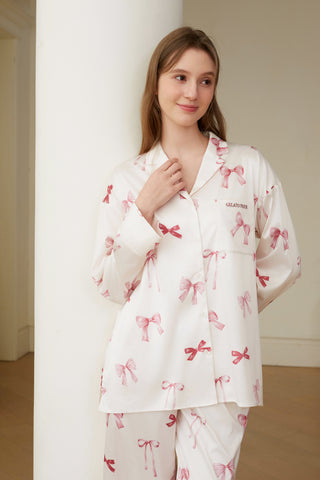 Woman wearing Ribbon Shirt & Long Pants Set with pink ribbon print and embroidered chest pocket, relaxed fit, stylish and feminine.