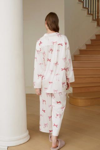 Women's ribbon shirt and long pants set in pink, featuring a relaxed fit with a notched collar and ribbon print, back view.