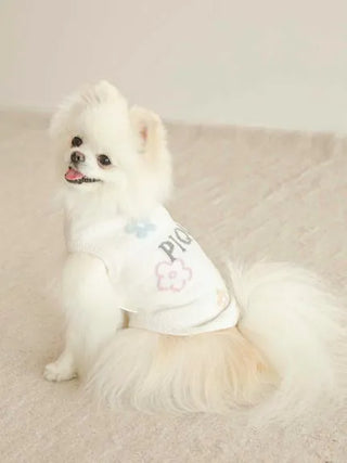 Small dog wearing a CAT&DOG Flower Logo Jacquard Pullover, featuring a floral design on a soft white fabric.