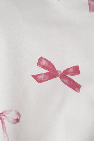 Close-up of pink ribbon print on fabric from Ribbon Shirt & Long Pants Set, featuring elegant feminine design.