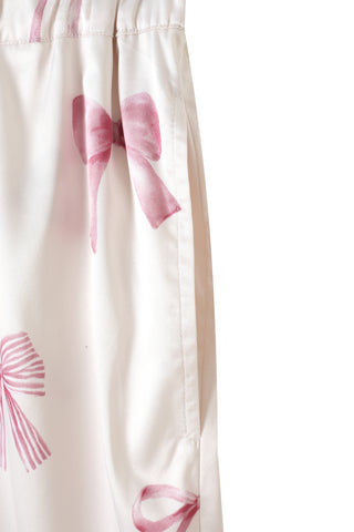 Close-up of long pants with pink ribbon print pattern from Ribbon Shirt & Long Pants Set, showcasing silky-white fabric.
