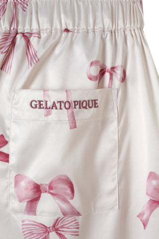 Close-up of a pink ribbon print on white pants with embroidered Gelato Pique pocket for the Ribbon Shirt & Long Pants Set.