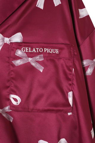 Close-up of silky pink ribbon print fabric with embroidered chest pocket, part of Ribbon Shirt & Long Pants Set by Gelato Pique.