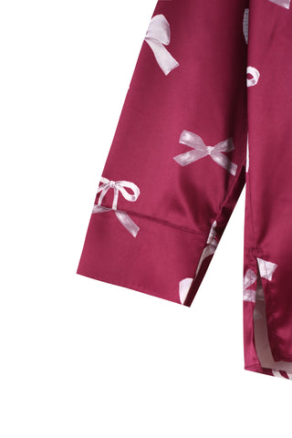 Close-up of a silky-soft ribbon printed shirt sleeve in pink, part of the Ribbon Shirt & Long Pants Set with a relaxed fit and feminine charm.