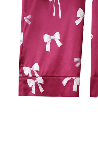 Close-up of pink long pants with white ribbon print, part of an elegant Ribbon Shirt & Long Pants Set. Ideal for stylish comfort.