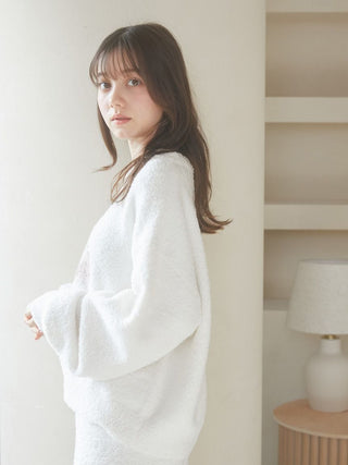 Woman wearing a Baby Moco CAT JQD Pullover Sweater with fluffy texture and voluminous sleeves, standing indoors.