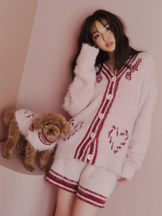 Woman and dog in matching pink feather knit pullovers with heart pattern from the Sending Warm Wishes collection.