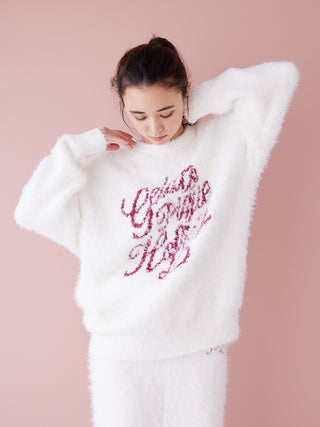 Woman wearing a festive feather pullover sweater with cozy, lightweight design; perfect for holiday comfort and style.