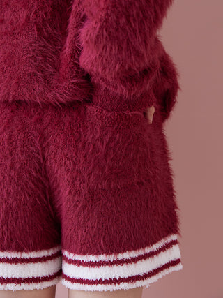 Luxurious feather lounge shorts in festive red with plush texture, designed for cozy comfort and stylish indoor wear.