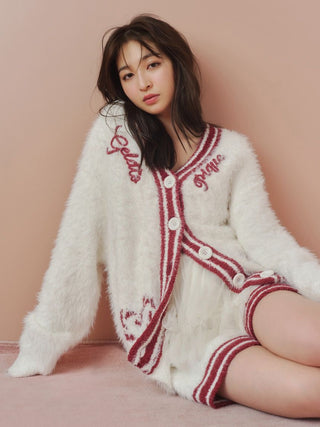 Woman wearing a cozy feather-textured cardigan and shorts set for loungewear, featuring a stylish varsity-inspired design.