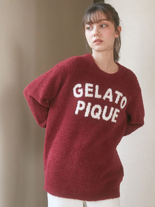 Woman wearing Chocolate & Framboise Baby Moco Pullover Sweater by Gelato Pique, featuring fluffy fabric and bold logo.