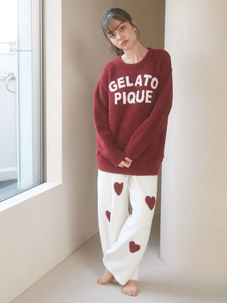 Model wearing Chocolate & Framboise Baby Moco Sweater by Gelato Pique USA, featuring a cozy, soft texture and bold logo.