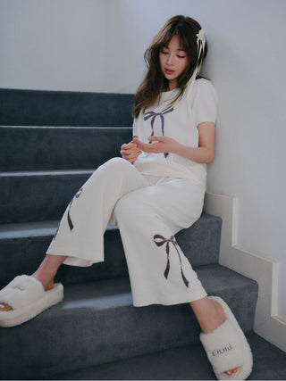 Model wearing Gelato Pique USA Ribbon Jacquard Pullover Sweater in off-white with puff sleeves; premium loungewear on staircase.