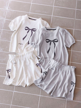 Alt Tag: Premium loungewear from Gelato Pique USA features off-white and blue ribbon jacquard pullovers and shorts with puff sleeves.