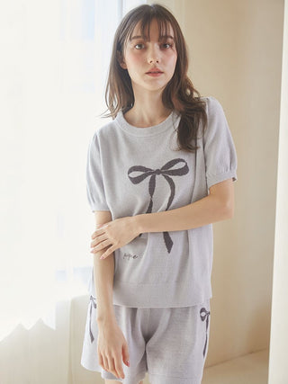 Woman wearing Gelato Pique USA premium loungewear ribbon jacquard pullover sweater in gray with puff sleeves and ribbon motif.