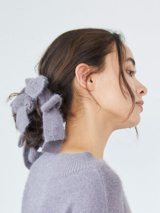 Woman wearing Gelato Pique Plush Bow Hair Ribbon with soft, cozy voluminous bows for a stylish look.
