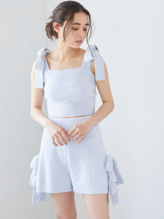 Woman wearing Gelato Pique Ribbon Lounge Shorts with ribbon accents, showcasing a playful and cozy design in light blue.
