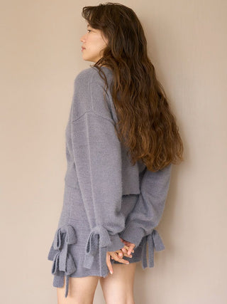 Woman wearing cozy gray Ribbon Lounge Shorts with ribbon accents, side view. Ideal for lounging or sleep, featuring soft, plush fabric.