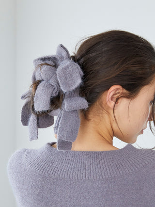 Woman wearing Gelato Pique's Plush Bow Hair Ribbon in gray, showcasing multiple plush bows for an elegant, voluminous hairstyle.
