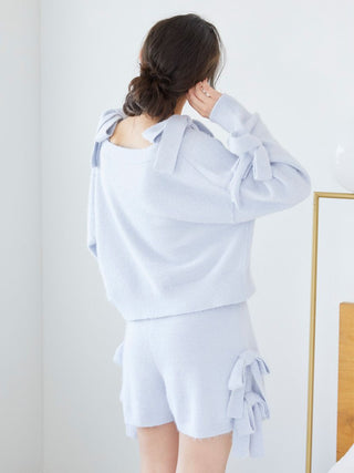 Woman wearing Gelato Pique Ribbon Lounge Shorts in light blue with ribbon accents, showcasing comfort and playful design.