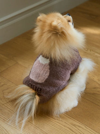 Fluffy dog wearing CAT&DOG Cupcake Sleeveless Pet Clothes in brown, sitting on wooden floor.