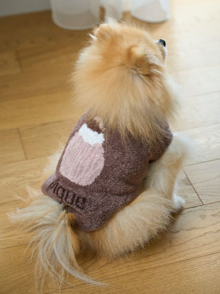 Pomeranian wearing CAT&DOG Cupcake Sleeveless Pet Clothes with a cupcake design, sitting on wooden floor.
