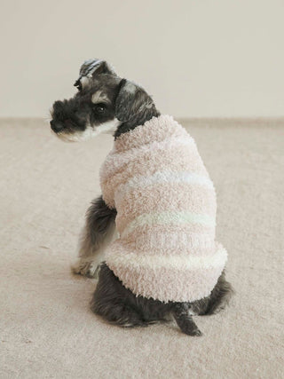 Dog wearing pastel-striped Gelato Colorful Border pet clothing, sitting on beige carpet, showcasing cozy and stylish pet apparel.