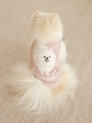 Pomeranian wearing pink CAT&DOG Baby Moco pet clothes with a cute dog print on the back, displayed on a soft beige surface.