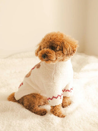 Cozy brown poodle wearing CAT&DOG Nordic pet clothes in a fluffy white setting.