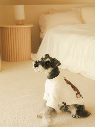 Small dog wearing CAT&DOG Heart Bear Jacquard Pet Clothes in a cozy bedroom setting.