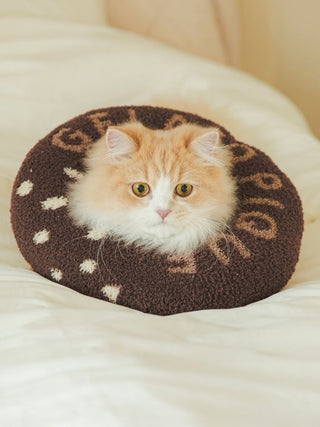 Fluffy cat comfortably resting in a brown Moco donut-shaped pet neck pillow for cats and dogs, enhancing pet relaxation.