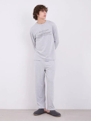 Model wearing men's inlay logo long pants in heather gray, featuring minimalist logo print and relaxed fit, perfect for loungewear.