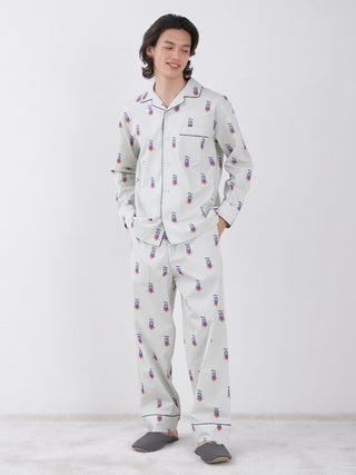 Man wearing KAZUSA MATSUYAMA Monster Pattern Lounge Pants with matching top in light beige color.