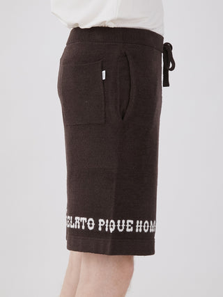 Side view of men's black logo jacquard lounge shorts, featuring a comfortable fit and stylish white logo embroidery on the hem.