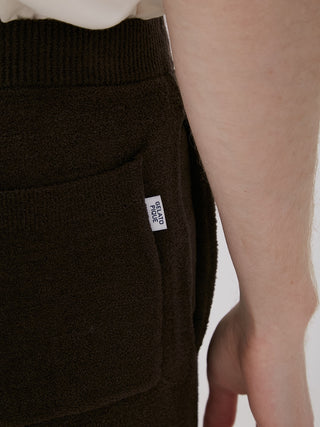 Close-up of Men's Logo Jacquard Lounge Shorts with HOMME label in soft, brown fabric, showcasing pocket detail.
