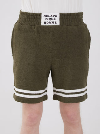 KOUSUKE SHIMIZU Air Moco Lounge Shorts by GELATO PIQUE HOMME in olive green with white stripes, front view.
