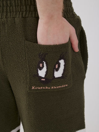 Close-up of KOUSUKE SHIMIZU Air Moco Lounge Shorts pocket design, featuring graphic art by Tokyo artist, in olive green color.