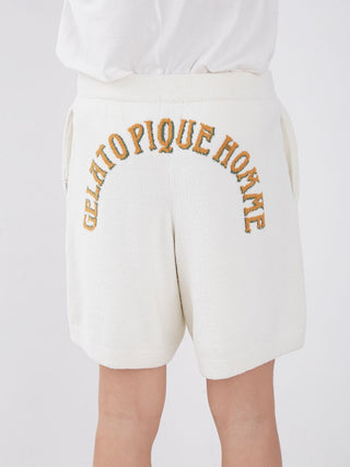 Back view of white Gelato Pique Homme lounge shorts with embroidered text, showcasing cozy and stylish loungewear.