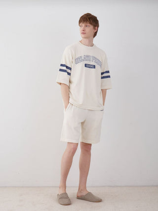 Man wearing Men's Air Moco College Lounge Shorts in a casual indoor setting.