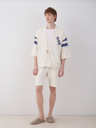 Man wearing Men's Air Moco College Lounge Shorts and matching top in a casual indoor setting, showcasing comfort and style.