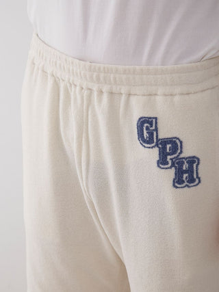 Close-up of Men's Air Moco College Lounge Shorts showing elastic waistband and embroidered logo in navy style.