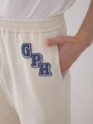 Close-up of Men's Air Moco College Lounge Shorts showcasing soft fabric and stylish logo embroidery detail.