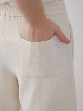 Close-up of Men's Air Moco College Lounge Shorts in cream color, highlighting the side pocket and soft fabric texture.