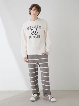 Man wearing Gelato Pique men's powder border lounge pants and sweater