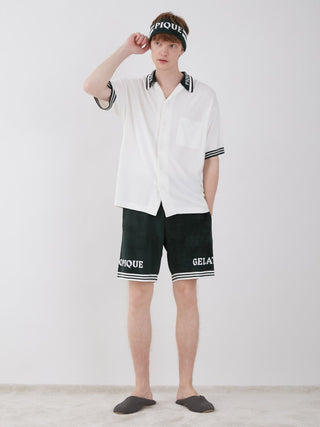 Model wearing a Smoothie Lite Tennis Logo Lounge Shirt with black shorts and matching headband, showcasing sporty chic style.