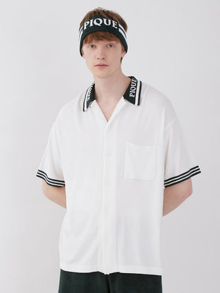 Model wearing Smoothie Lite Tennis Logo Lounge Shirt, retro-inspired, white with striped collar and sleeves for sporty chic style.