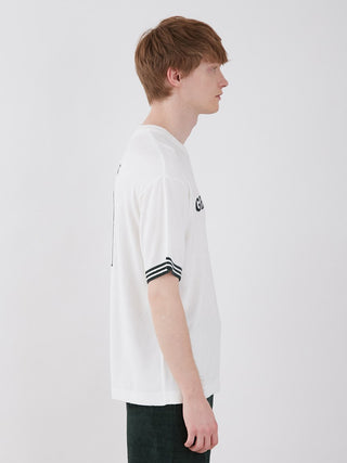 Side view of a man wearing a white Smoothie Lite Tennis Logo Lounge Top with retro design and logo on sleeves.