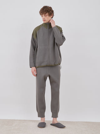 Man wearing OCEANS Plating Moco ECWCS Blouson Jacket in gray, showcasing luxury knit fashion by Gelato Pique.